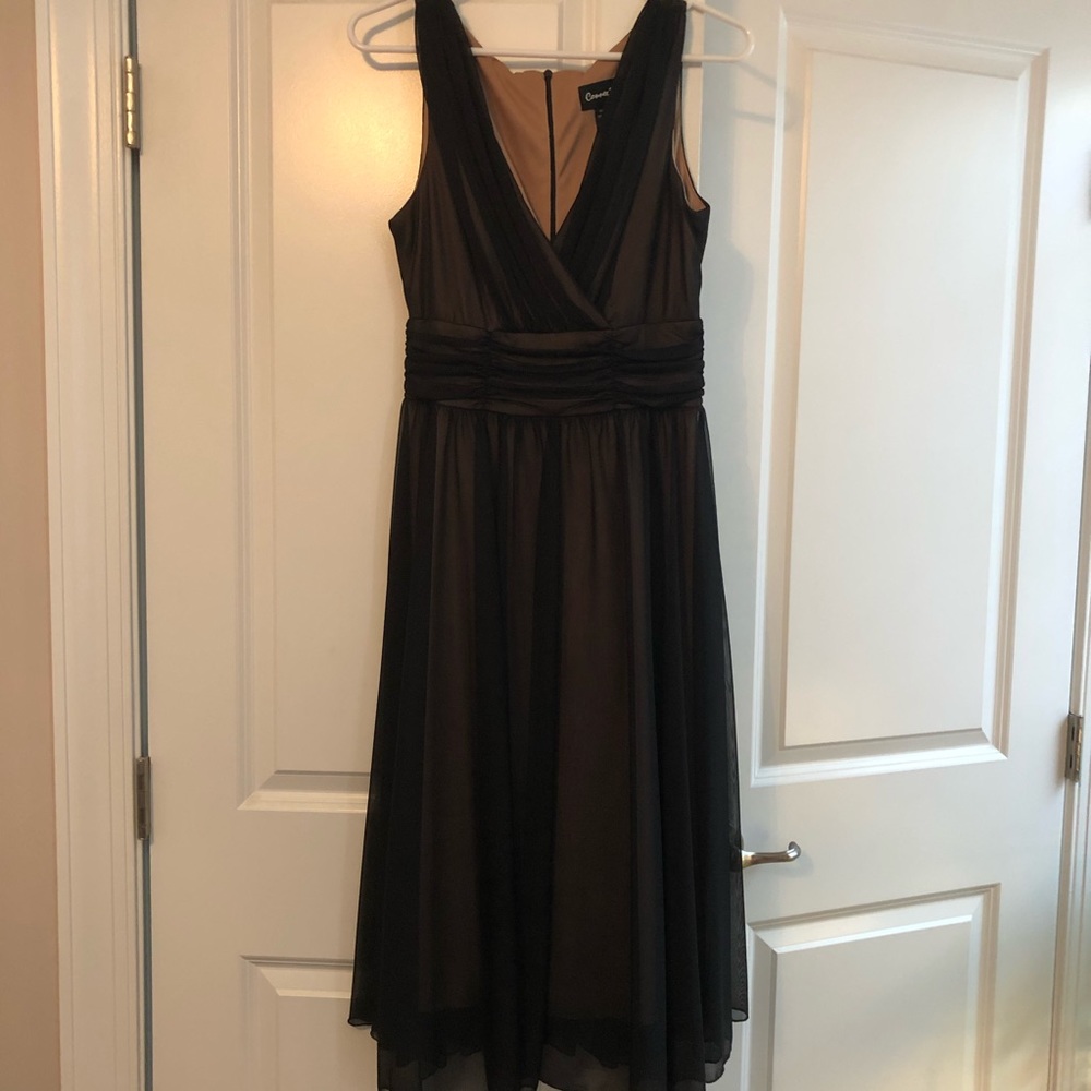 Connected black dress with a beige lining.